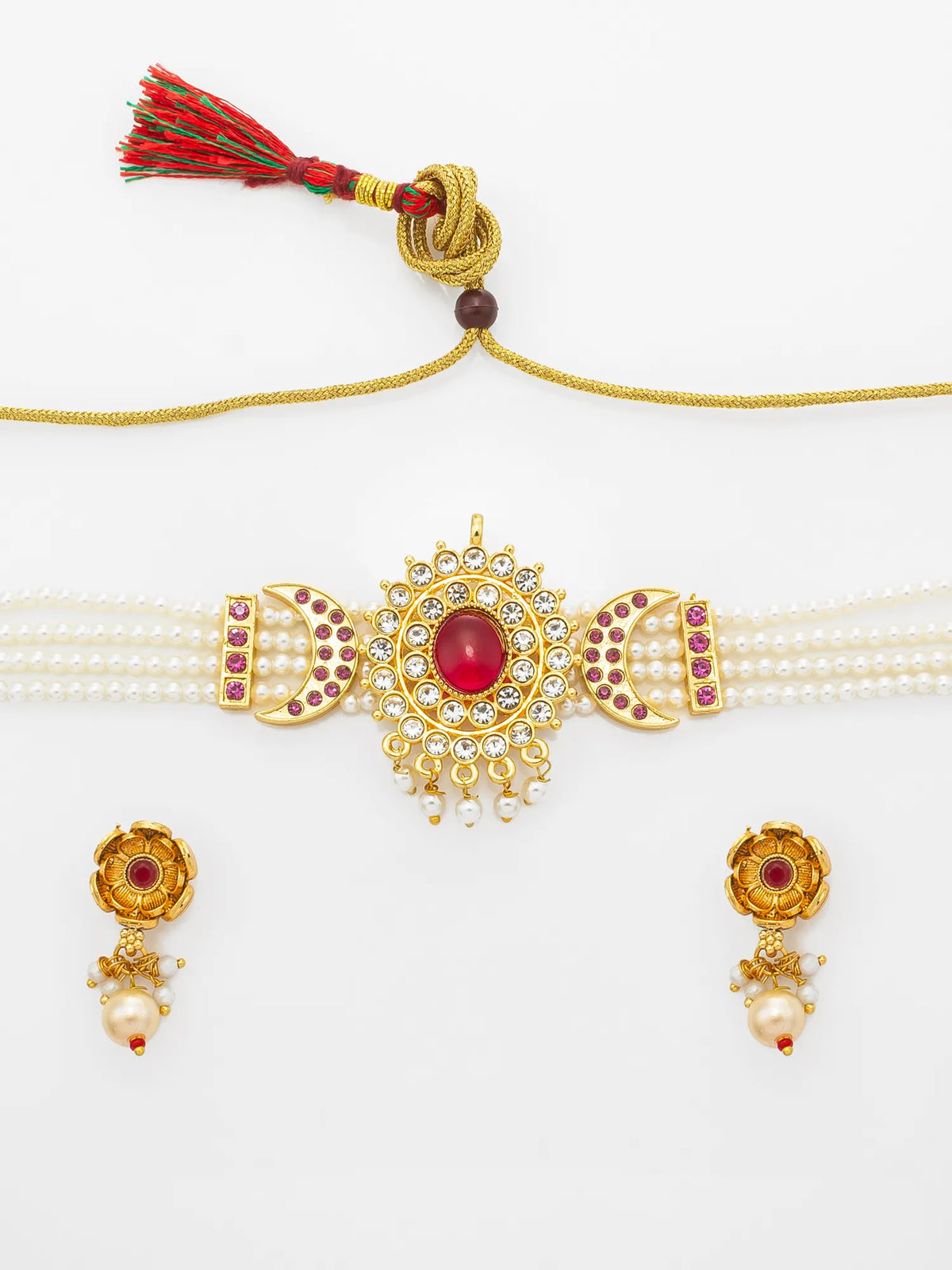 Gold-toned traditional jewelry set featuring a pearl-strand collar with a central red gemstone and tassel, paired with matching drop earrings on a plain white background.