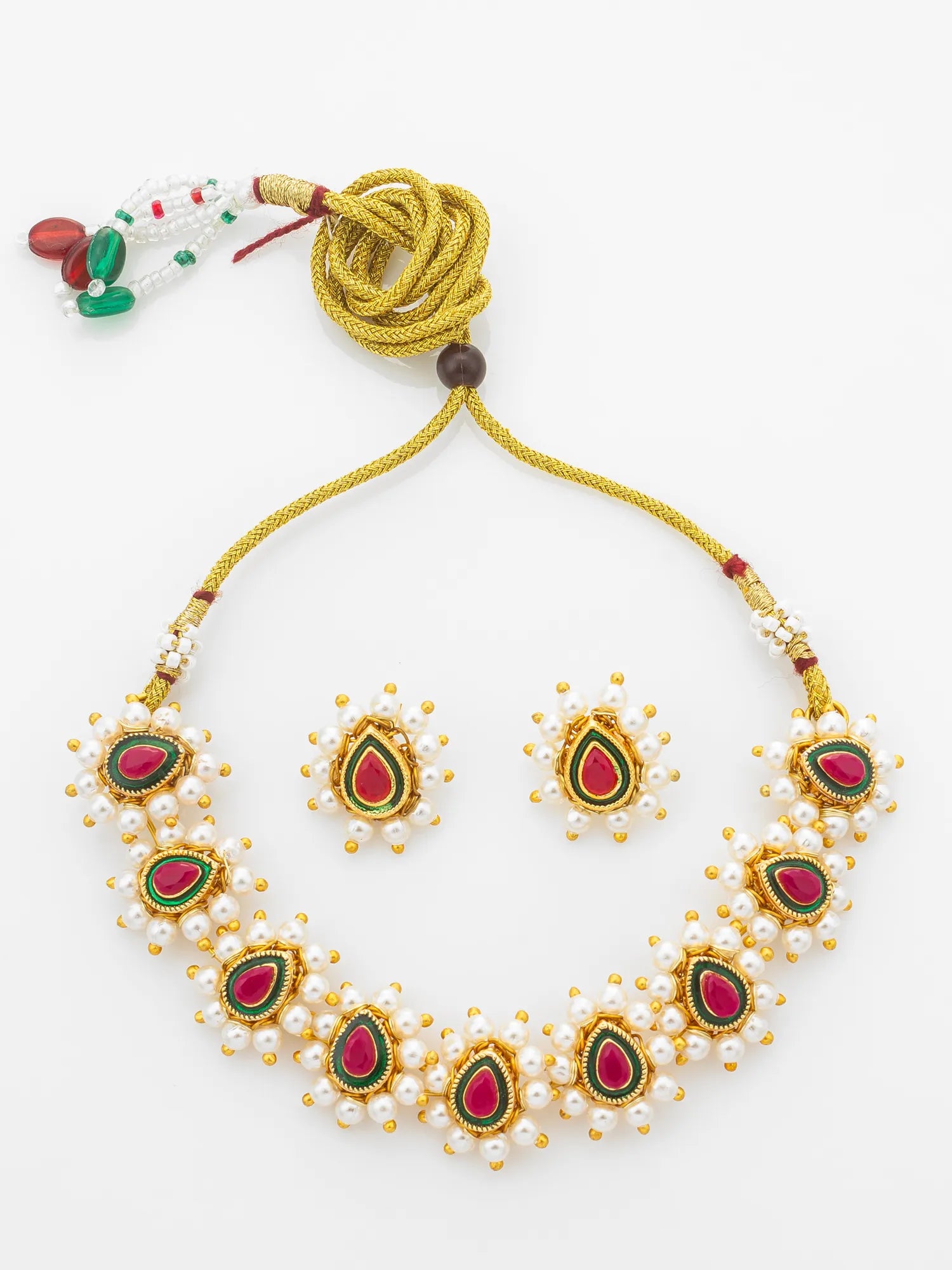 A traditional Indian jewelry set featuring a gold-plated necklace and matching earrings with red, green, and white enamel details and pearl-like bead borders, displayed on a clean white background.