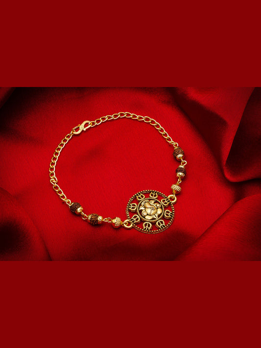 Gold bracelet with decorative elements on a red fabric background