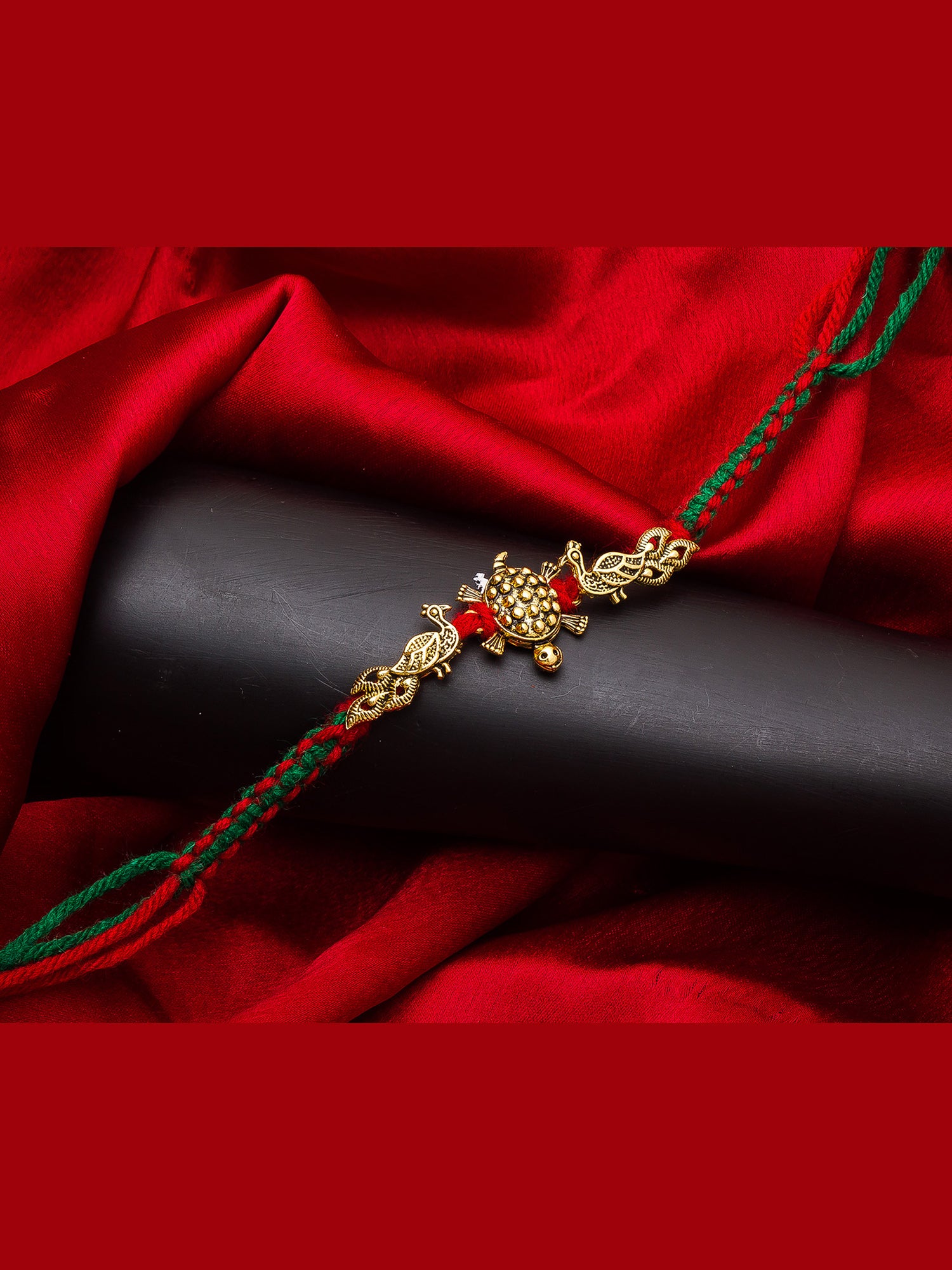 Aadita Traditional Tortoise Design Rakhi on Red-Green Thread